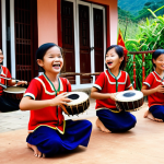 **

A heartwarming scene of children in a rural Vietnamese village joyfully playing traditional musical instruments like the *đàn bầu* and *đàn tranh*. The instruments are donated and well-used. The setting is a community center decorated with colorful folk art. Focus on the children's happy expressions and the vibrant cultural atmosphere.

**